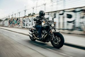 Motorcycle riding a coastal road with the ocean in the background